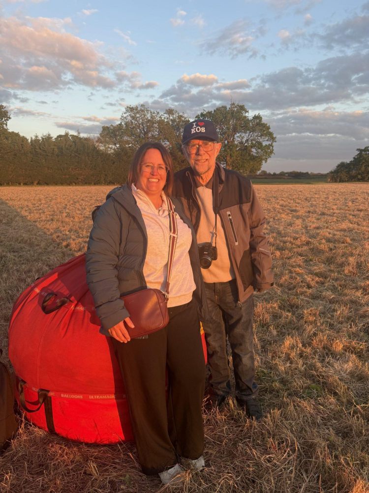 couple photo next to packed away balloon after private hot air balloon ride over east midlands