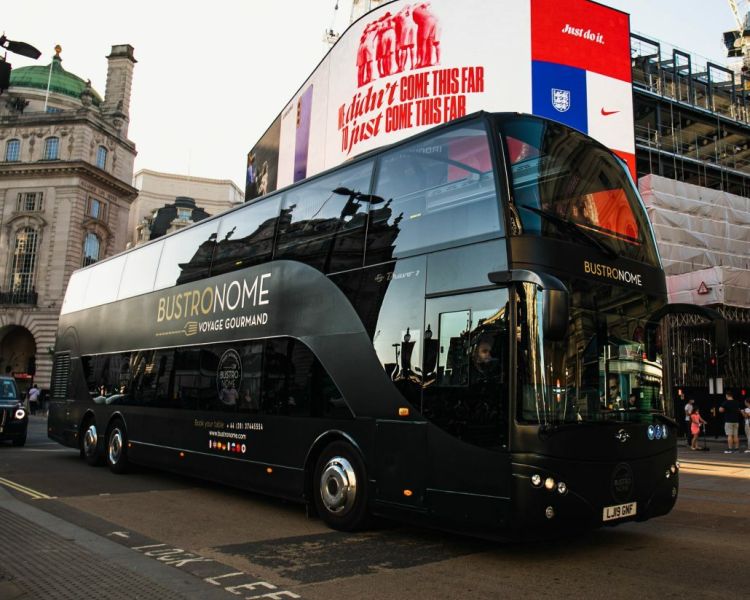 the converted black double decker bus in london for the gourmet six course bustronome london dinner experience