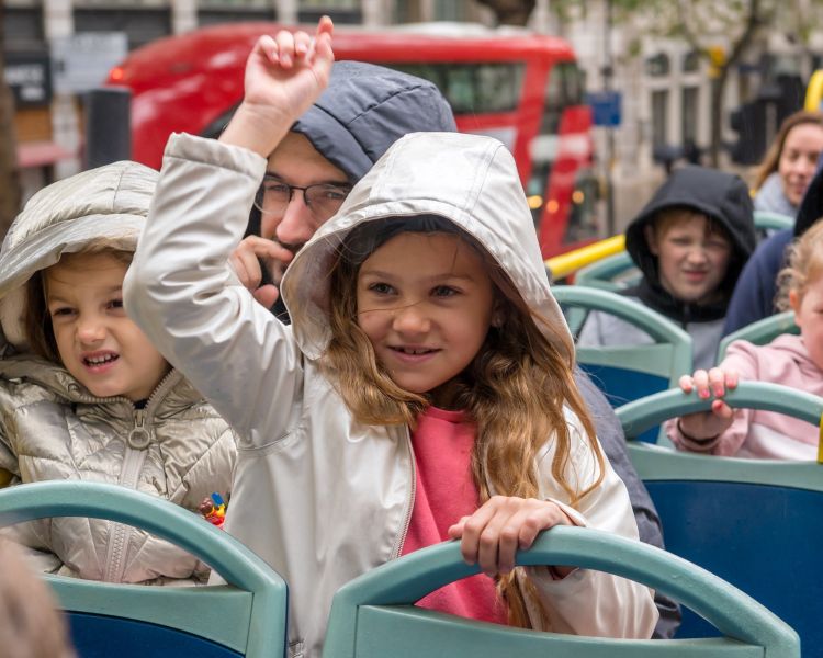 kids on top deck of london bus tour