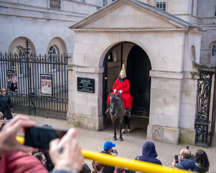 view from top deck of the original london bus tour of guard outside royal palace