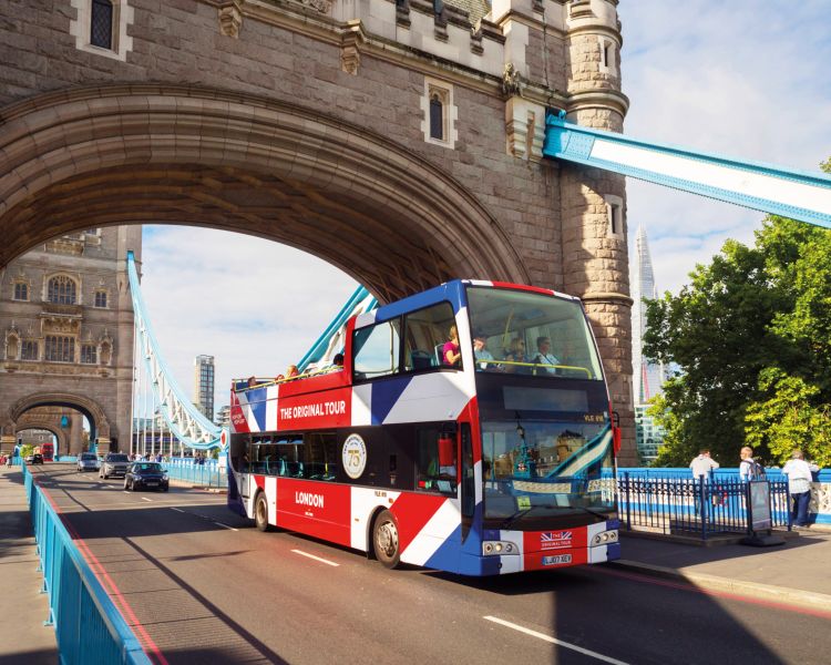 the original london bus tour going over tower bridge