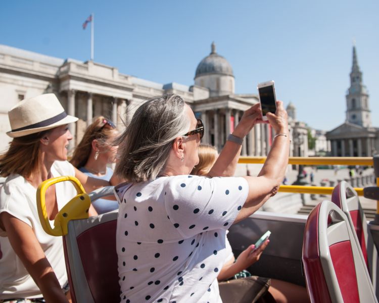 view from top deck of the original london bus tour going past buckingham palace