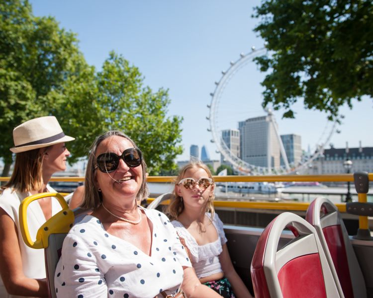view from top deck of the original london bus tour going past the london eye