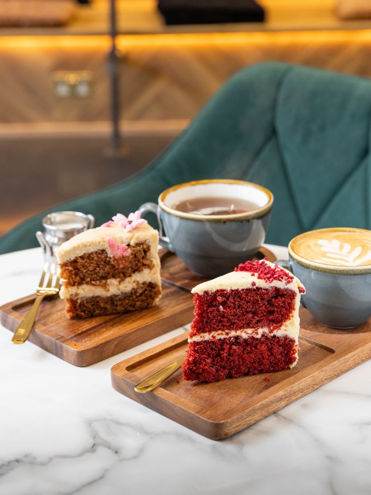 Two pieces of cake with tea and coffee at jack and beyond