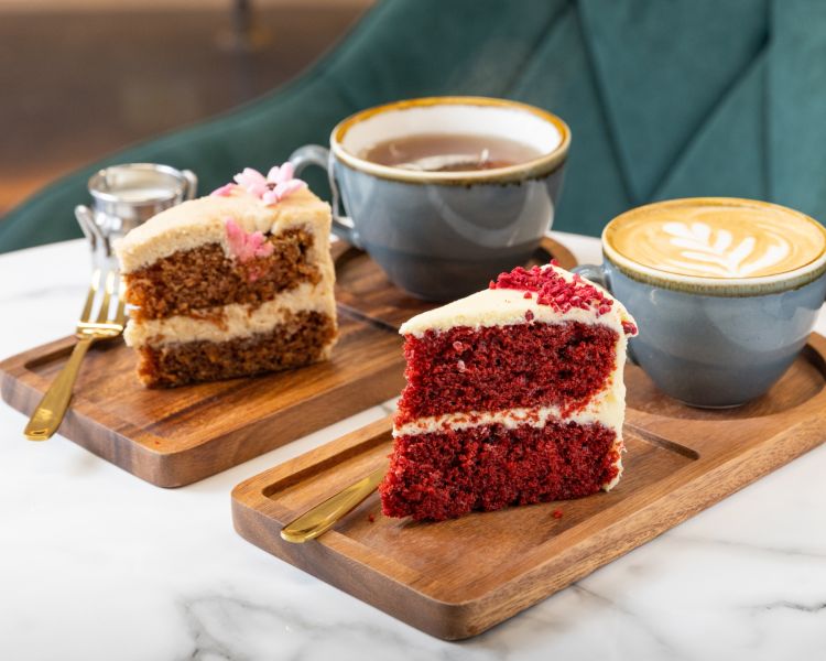 Two pieces of cake with tea and coffee at jack and beyond