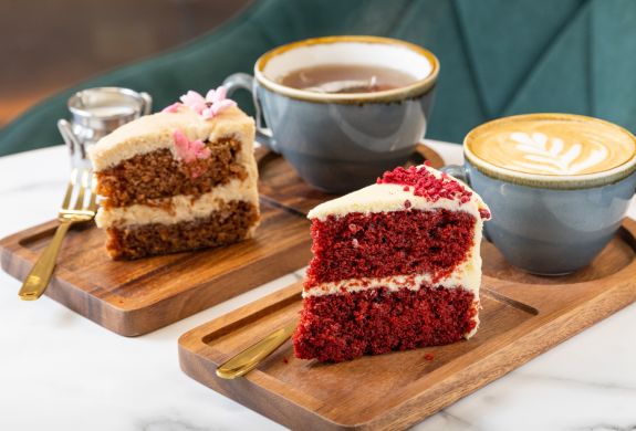 Two pieces of cake with tea and coffee at jack and beyond