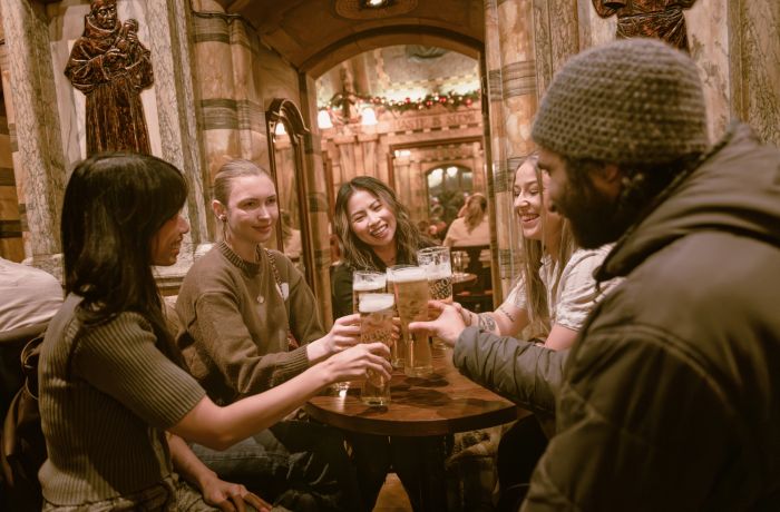 Group with beers in pub on london pub tour