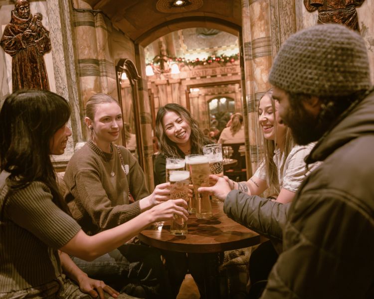 Group with beers in pub on london pub tour