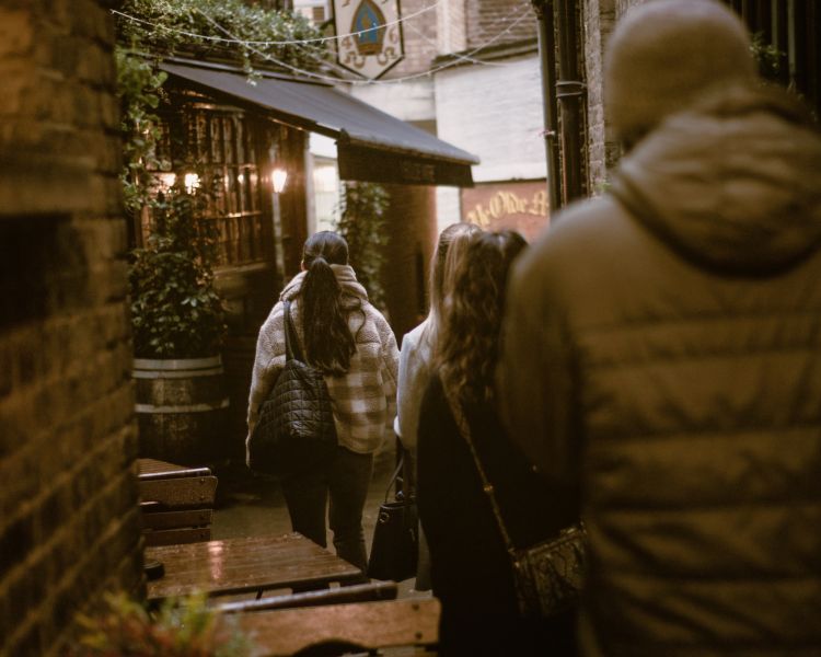 Walking down alleyway on london pub tour
