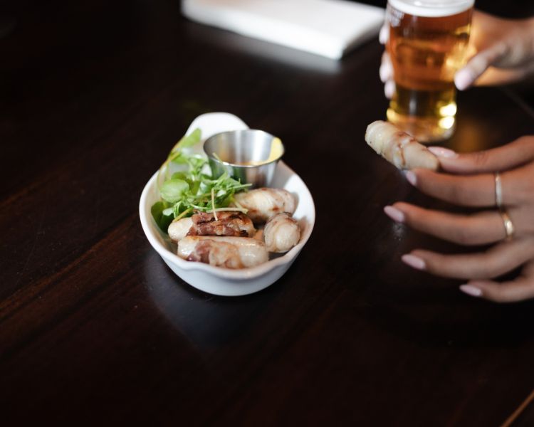 Pub snack of sausages had on london pub and food tour
