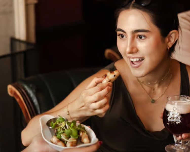 Trying bar snack with beer on london pub and food tour