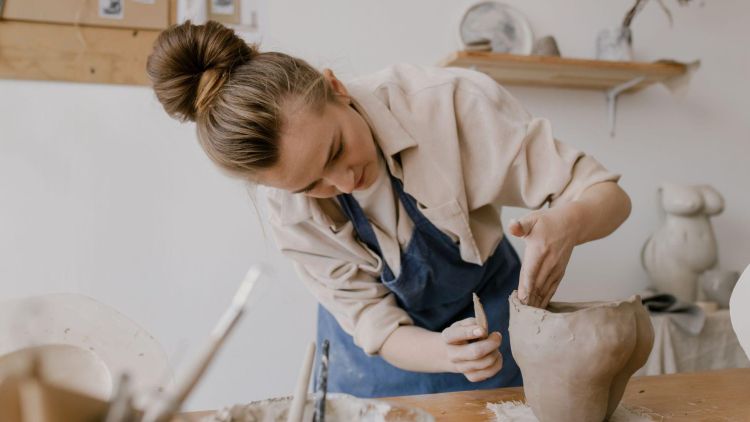 women making something out of clay on a pottery experience day