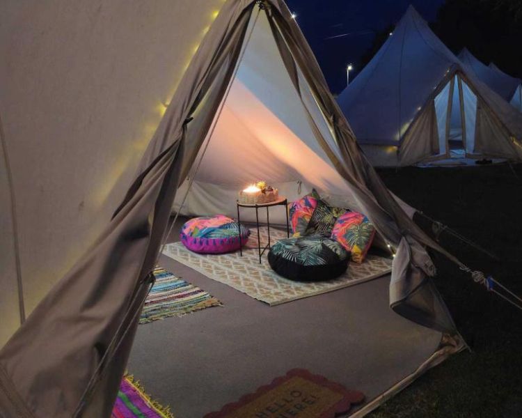 Bell tent at night on glamping site near stonehenge