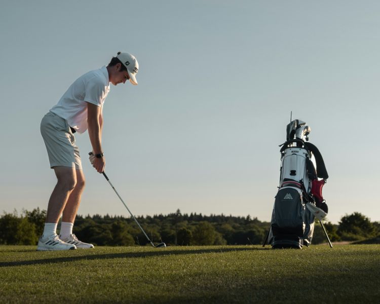 teenage boy playing golf