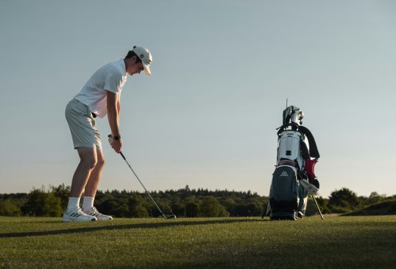 teenage boy playing golf