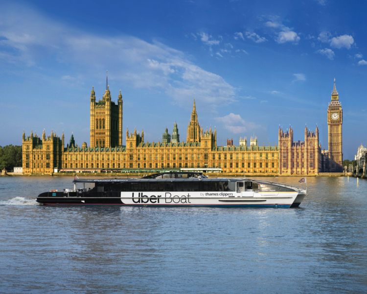 Uber boat passes the houses of parliament