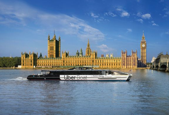 Uber boat passes the houses of parliament