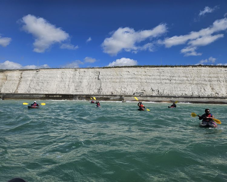 kayaking in front of white cliffs on kayaking experience off brighton coast