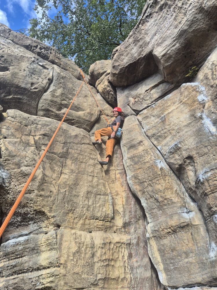 person halfway up cliff on rock climbing experience in sussex and kent