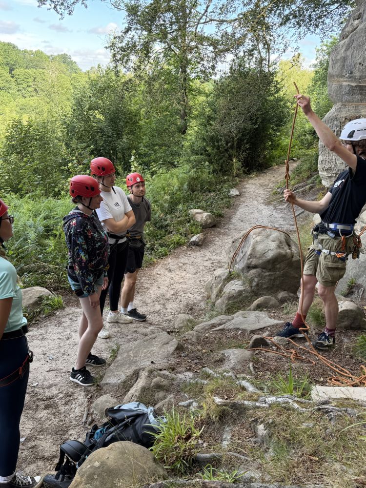 group being shown rope tying techniques on rock climbing experience in sussex and kent