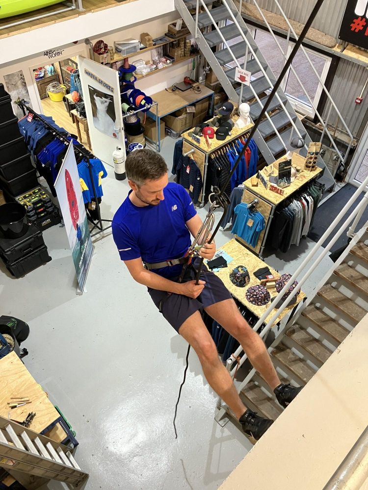 man trying out indoor abseiling in brighton
