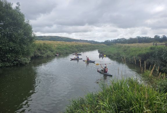 aerial shot of group kayaking down a sussex river