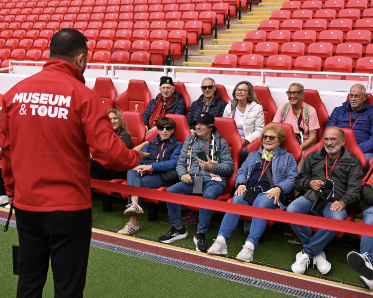 Group on pitch side liverpool fc and museum tour