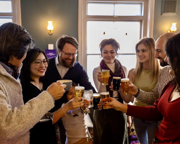 group with drinks in pub on food tour through london's chinatown and soho