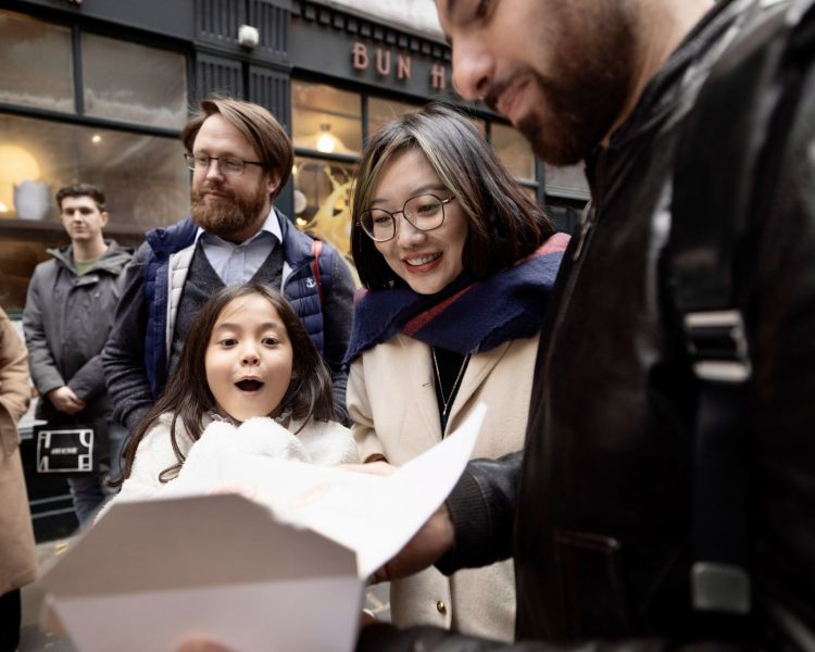 people opening food boxes on food tour through london's chinatown and soho