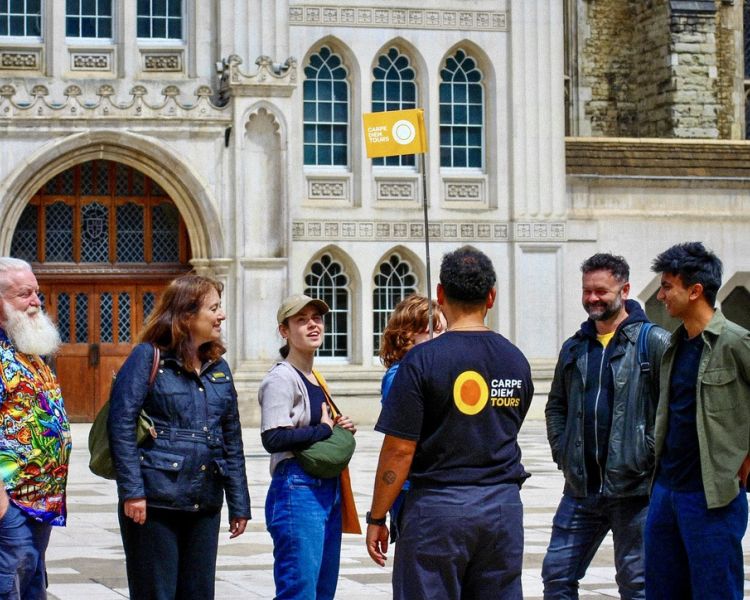 tour group and guide on london street on british empire walking tour in london