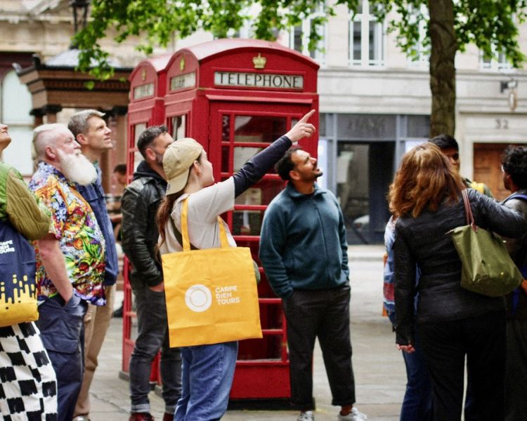 group looking up on british empire walking tour in london
