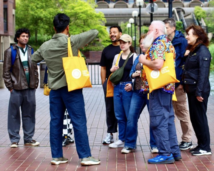 group listening to guide on british empire walking tour in london