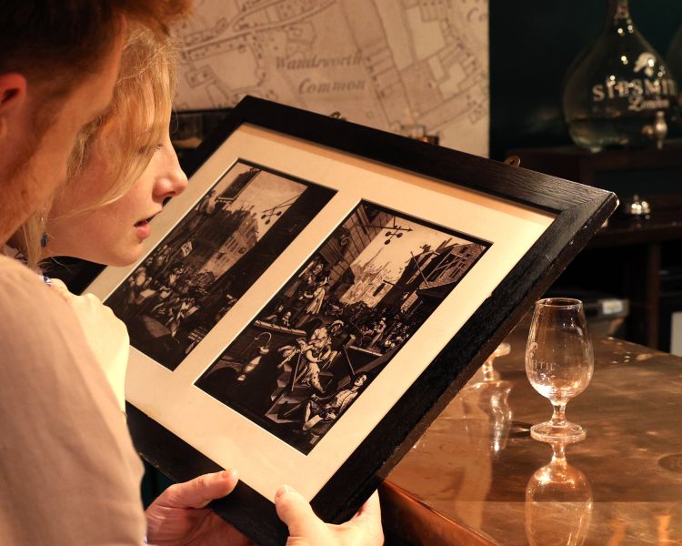 looking at old photos on a sipsmith london gin distillery tour and tasting