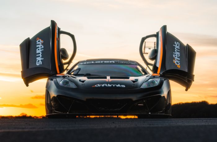 a mclaren on the track as part of a ferrari 458 challenge vs lamborghini or mclaren driving experience