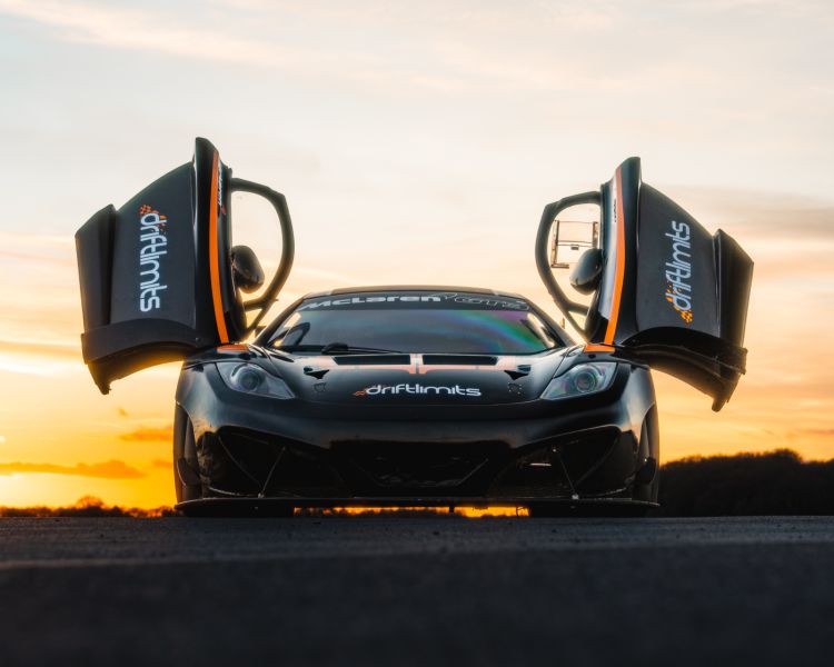 a mclaren on the track as part of a ferrari 458 challenge vs lamborghini or mclaren driving experience