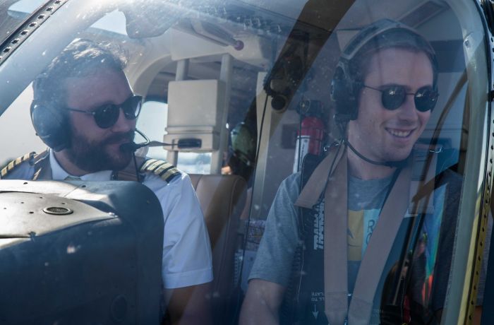 man in the co-pilot seat next to the pilot on a helicopter ride experience with adventure 001