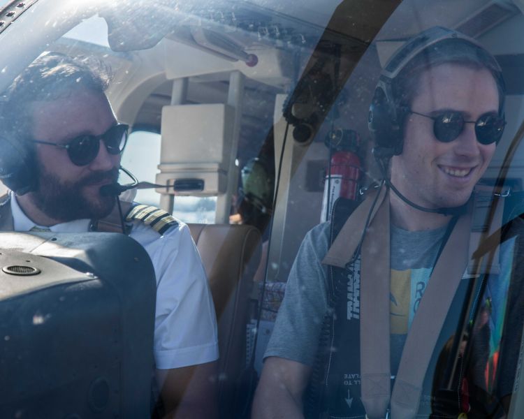 man in the co-pilot seat next to the pilot on a helicopter ride experience with adventure 001