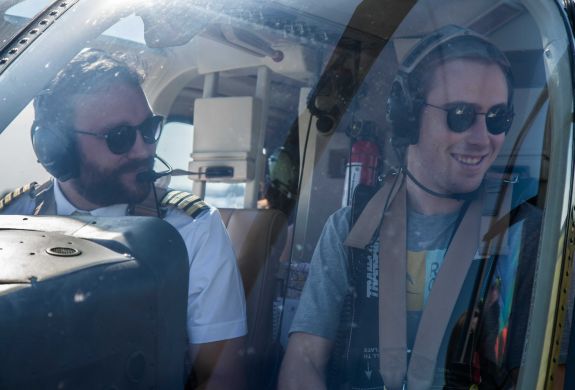 man in the co-pilot seat next to the pilot on a helicopter ride experience with adventure 001