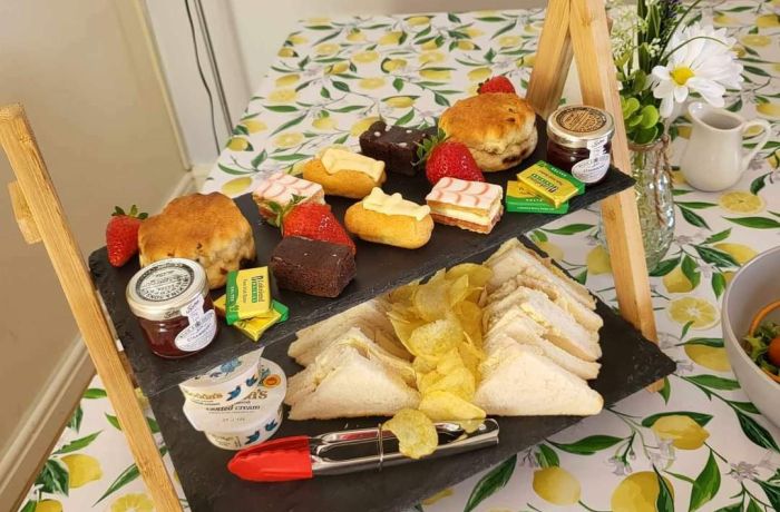 an afternoon tea displayed on a cake stand on a table in the tea room of little skipworth carriage rides