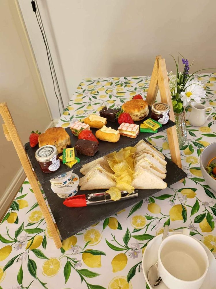 an afternoon tea displayed on a cake stand on a table in the tea room of little skipworth carriage rides