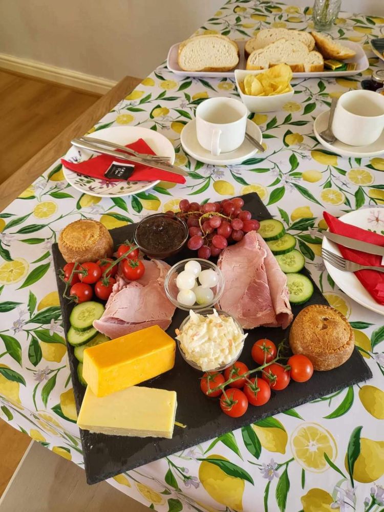 a savoury spread of cheese, meats and bread on a table in the tea room at little skipworth carriage rides