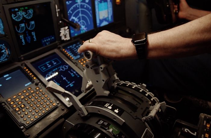 a mans hand on the controls in a plane flight simulator at deeside flight simulators