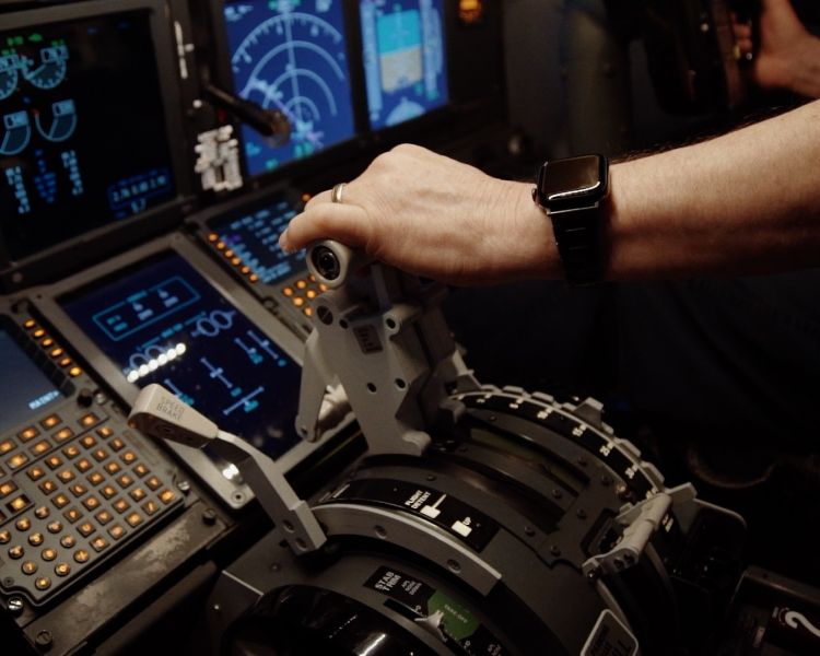 a mans hand on the controls in a plane flight simulator at deeside flight simulators