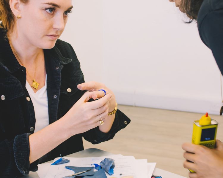person receiving guidance during a gemstone jewellery making workshop with stööki