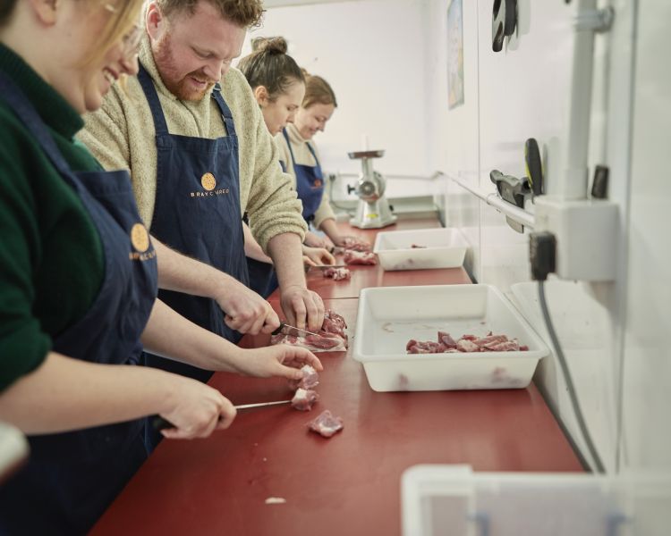 learning butchery skills on a sausage making class