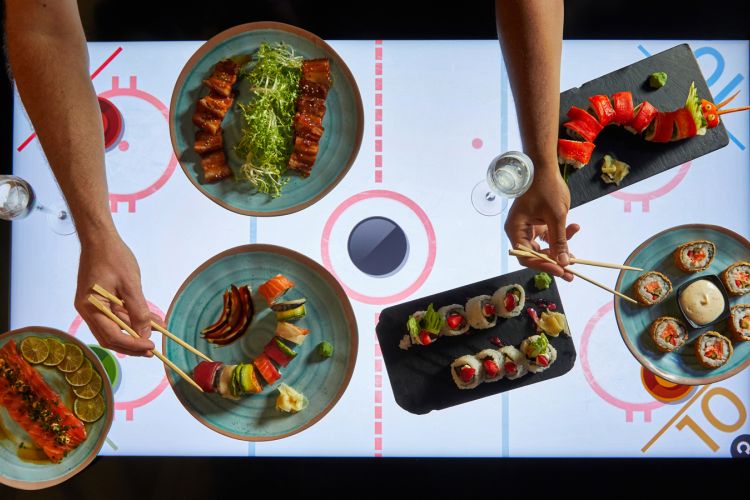 Dishes on table with air hockey beneath