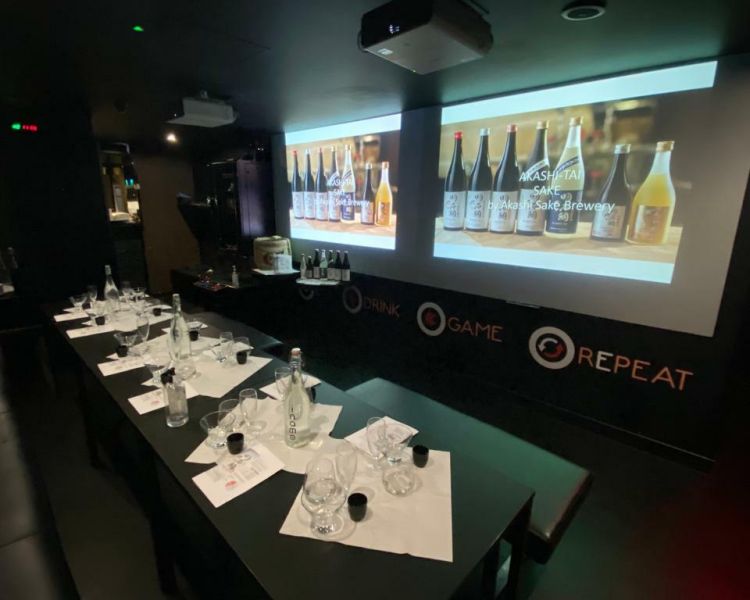 table with big screen prepared for a sake tasting at inamo london