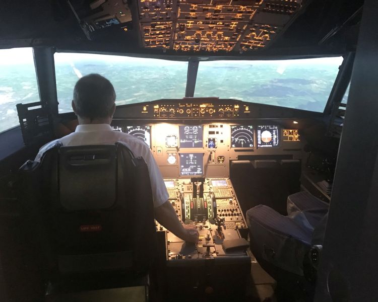 person in the cockpit of an airbus flight simulator at Deeside