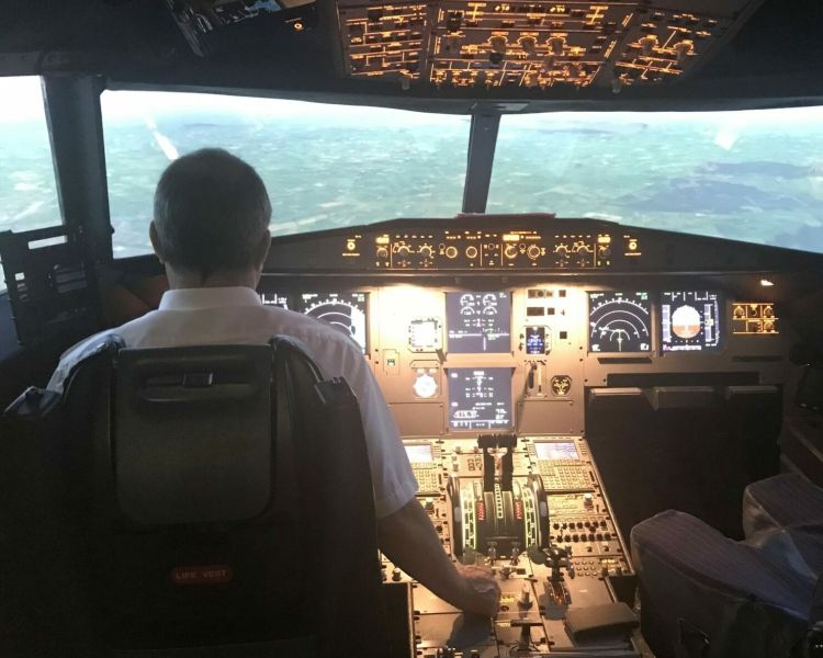 person in the cockpit of an airbus flight simulator at Deeside