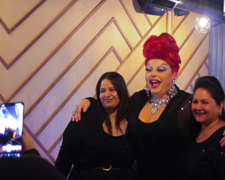 drag queen posing for photos with guests at inamo london